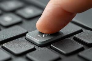 Finger pressing sell button on computer keyboard photo