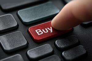 Finger presses buy button on keyboard photo