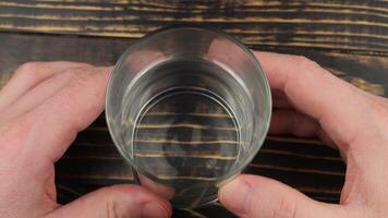 A person holding a glass with a hole in it video