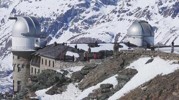 Aerial view of Gornergrat Observatory near Zermatt with Matterhorn peak in the background, showing snow covered mountains and smooth camera motion. video