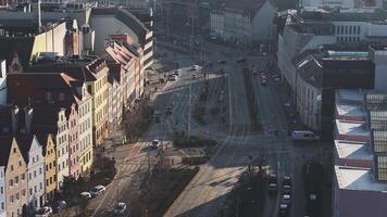 Aerial view of Wroclaw, Poland, showcasing the Sky Tower, red tiled roofs, and historic brick towers under a hazy, diffused light. video