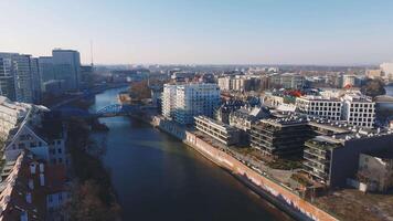 Aerial view of Wroclaw, Poland, featuring the Oder River, a blue bridge, historic red roofed buildings, modern architecture, and green spaces. video