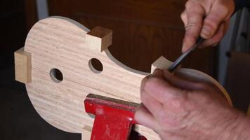 Luthier working in the structure of a new viola or violin video