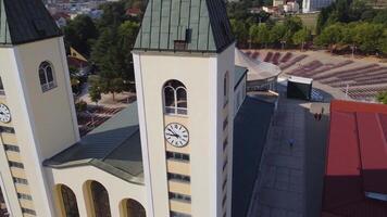 Close up view of the church of Medjugorje symbol of the city and of the apparition of the Madonna. Drone view of the landmark structure of prayer and pilgrimages video