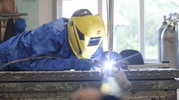 Man wearing mask welding in a workshop. Metal workers use manual labor. Skilled welder. Welder is welding the stainless steel pipes in the factory. welder Industrial part in factory. 3 video