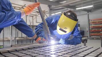 Man wearing mask welding in a workshop. Metal workers use manual labor. Skilled welder. Welder is welding the stainless steel pipes in the factory. welder Industrial part in factory. 2 video