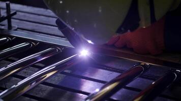 Man wearing mask welding in a workshop. Metal workers use manual labor. Skilled welder. Welder is welding the stainless steel pipes in the factory. welder Industrial part in factory. 12 video