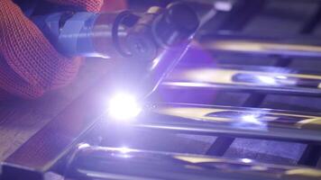 Man wearing mask welding in a workshop. Metal workers use manual labor. Skilled welder. Welder is welding the stainless steel pipes in the factory. welder Industrial part in factory. 11 video