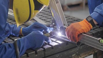 Man wearing mask welding in a workshop. Metal workers use manual labor. Skilled welder. Welder is welding the stainless steel pipes in the factory. welder Industrial part in factory. 4 video