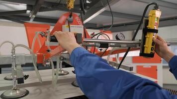 Worker uses suction cups for transporting large sheets of metal 2 video