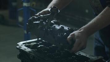 Car mechanic in garage with car engine after remove the cover part. Mechanic hands opens engine for repair. Auto service 2 video