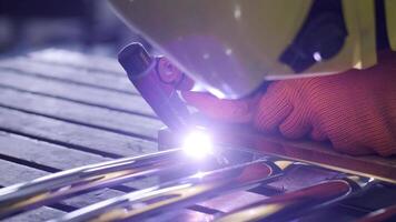Man wearing mask welding in a workshop. Metal workers use manual labor. Skilled welder. Welder is welding the stainless steel pipes in the factory. welder Industrial part in factory. 10 video