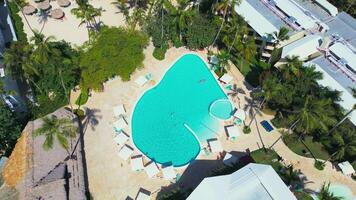Flight around a tourist swimming pool located at an all-inclusive hotel video