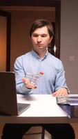 vertical Office worker showing shopping cart at desk with laptop and folders video