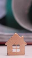 vertical Real estate agent browsing documents with miniature house in focus video