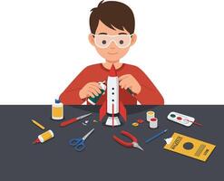 Young boy assembling a model rocket with various crafting tools on a table dsadqwd vector