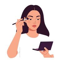Woman applying makeup with brush while holding compact mirror in front of her face vector