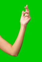 Hand gesture against a vibrant green background with soft contours and a relaxed pose photo