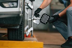 Wheel changing. Man is works, in the automobile repairing salon photo