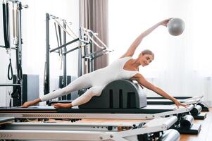 Using fitness ball., Young woman is ,doing exercises photo