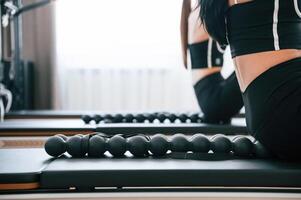 Using device, with, circles for the spine. Women in fitness center are doing exercises photo