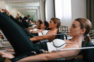 Legs, stretching,. Women in fitness center are doing exercises photo