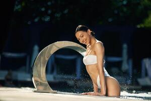 Conception of resort, and relax. Woman in white underwear is in the pool photo