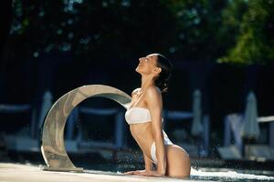 Conception, of resort and relax. Woman in white underwear is in the pool photo