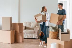 Bright big ,appartment. Young, couple, with dog are moving to new home photo