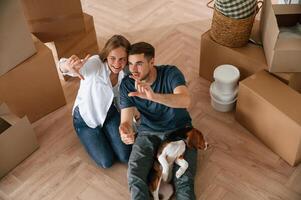 Top, view. .Young ,couple with dog are moving to new home photo