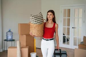 Young woman, in casual clothes is moving to new house photo