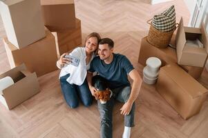 Looking at ,appartment.. Young couple with dog are moving to new home photo