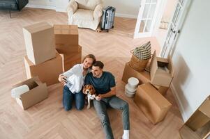 Looking at appartment., Young couple with dog are moving to new home photo