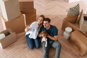 Looking at appartment., Young ,couple with dog are moving to new home photo