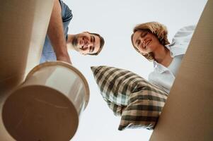 View from, the inside of a box. Young couple moving to new home photo
