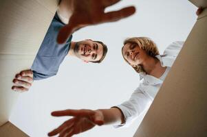 View,, from the inside of a box. Young couple moving to new home photo