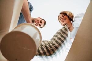 View, from the inside of a box. Young couple moving to new home photo