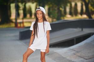 Young, girl in casual clothes is in the public park outdoors photo