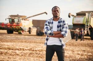Standing ,with ,arms crossed. Beautiful African American man is in the agricultural field photo