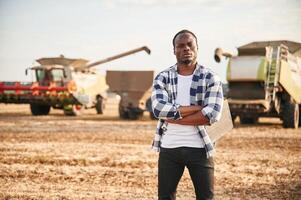Standing with ,arms crossed. Beautiful African American man is in the agricultural field photo