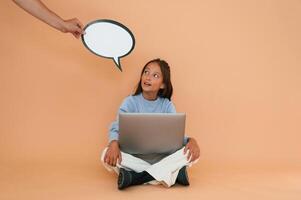 Hand, is holding, sticker with copy space for text, thoughts. Sitting with laptop. Cute young girl photo