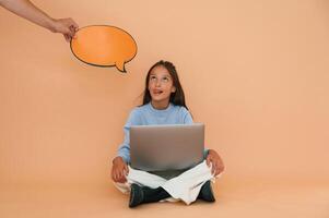 Hand is holding sticker, with ,copy space for text, thoughts. Sitting with laptop. Cute young girl photo