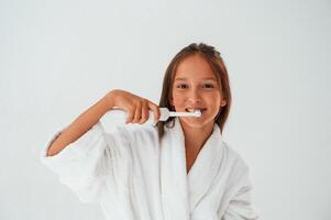 Using, the, toothbrush. Conception of beauty and self care. Young girl is in the studio photo