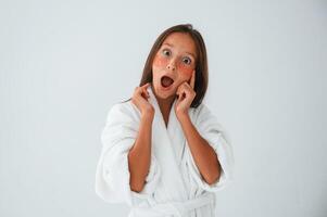 Positive and surprised facial, expression.. With eye patches. Conception of beauty. Young girl is in the studio photo