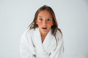 Positive and surprised, facial expression. With eye patches. Conception of beauty. Young girl is in the studio photo