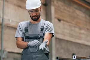 Young factory worker in grey uniform., photo