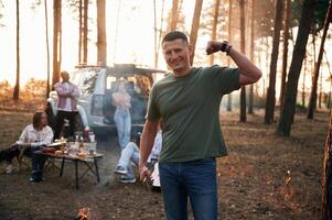 Happy, man is smiling.. Group of friends are together in the forest photo