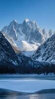 Snow-Covered Mountains and Frozen Lake Landscape photo