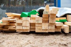 Stack of Wooden Planks at Construction Site with Protective Padding photo
