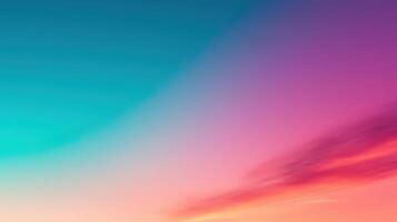 A colorful sunset with a blue sky and orange and pink clouds photo